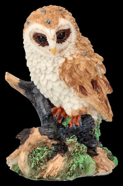 Owl Figurine sitting sceptically on branch