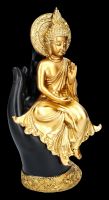 Buddha Figur sitzt auf Hand