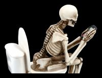 Skelett Figur sitzt auf WC