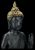 Schwarze Buddha Figur mit erhobener Hand