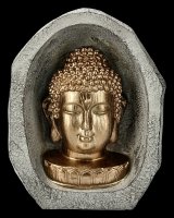 Gold colored Buddha Bust in a Rock