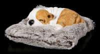 Dog Figurine asleep on grey Blanket