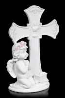 White Cherub Figurine praying in front of Cross