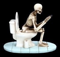 Skelett Figur sitzt auf WC