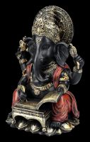 Ganesha Figur schreibt in Buch